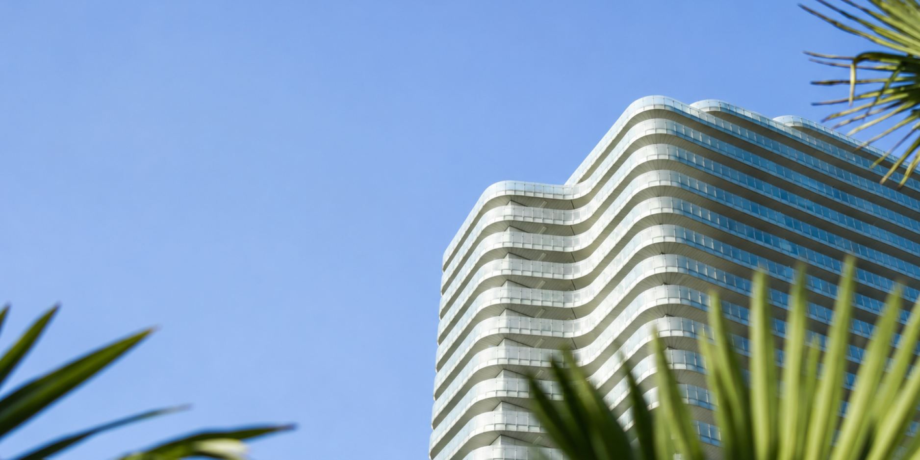 A modern hotel in Sochi against a backdrop of sea and palms